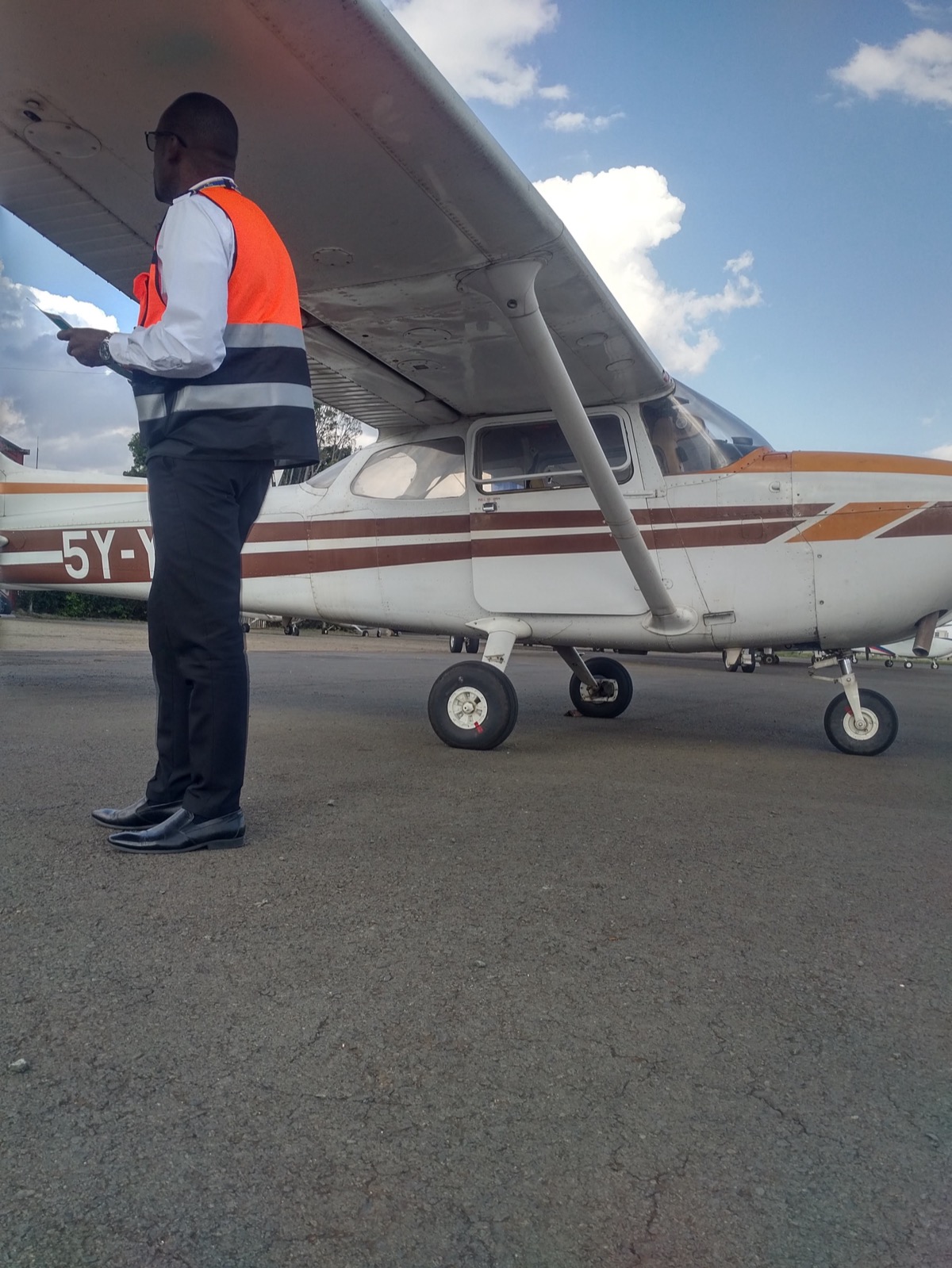 Licensed aircraft engineer performing pre-flight safety inspection at Standards Aviation Nairobi